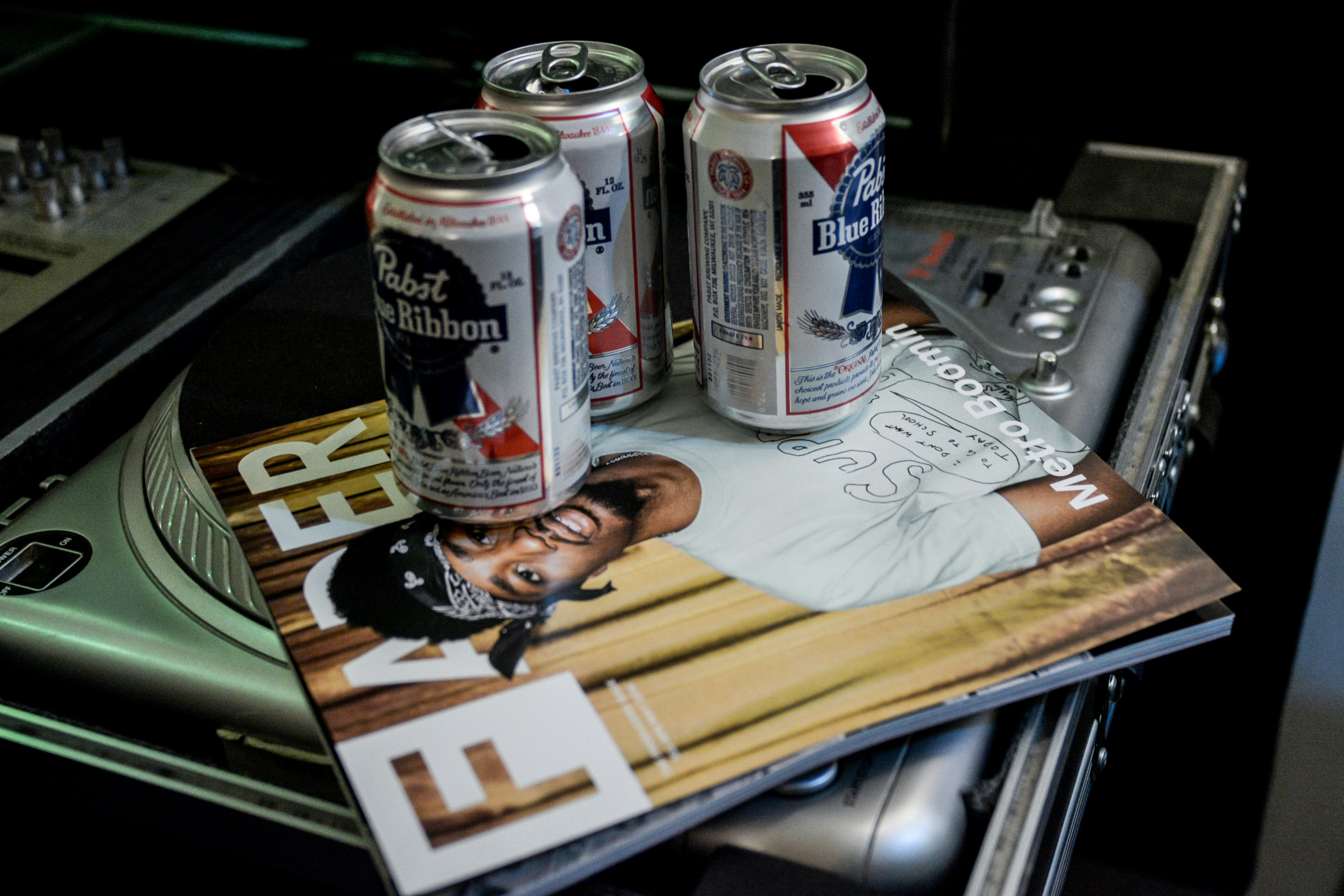 gray and red can on brown wooden table